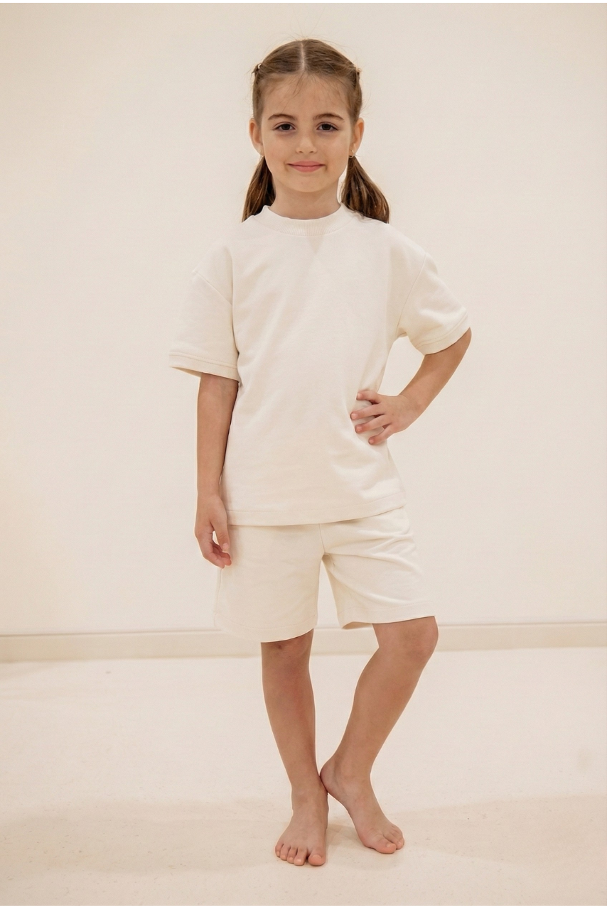Little Yogi yoga uniform flat lay — T-shirt and shorts in Peach colourway